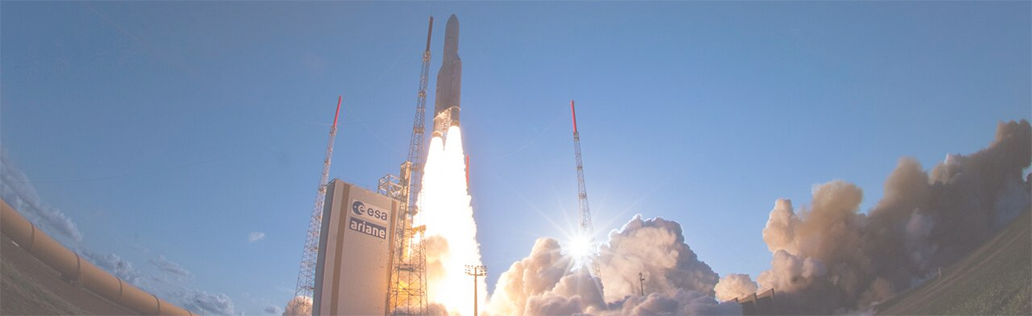 A view from the ground of a rocket launching into space with plumes of flames and smoke coming from the engines.