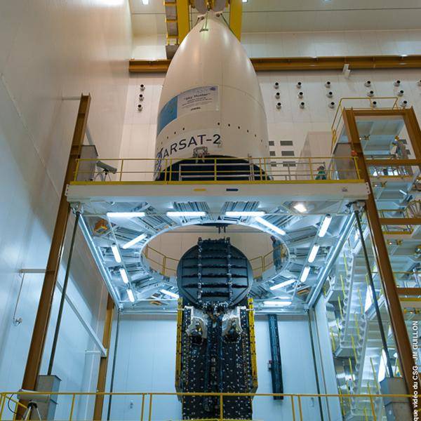 A view from below of nbn's Sky Muster rocket hanging inside a building prior to being launched into space