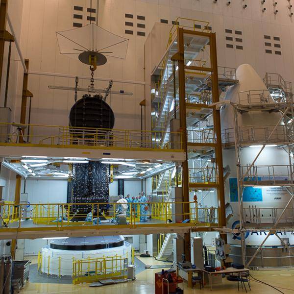 A wide angle view spanning three levels in a building showing inside and outer capsule of nbn's Sky Muster Satellite rocket