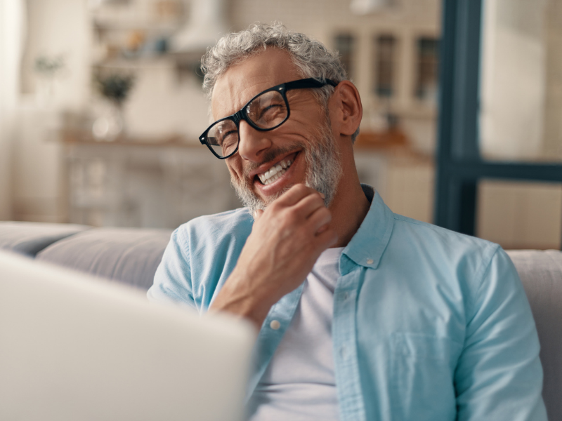 man-smiling-home-laptop-couch - 1