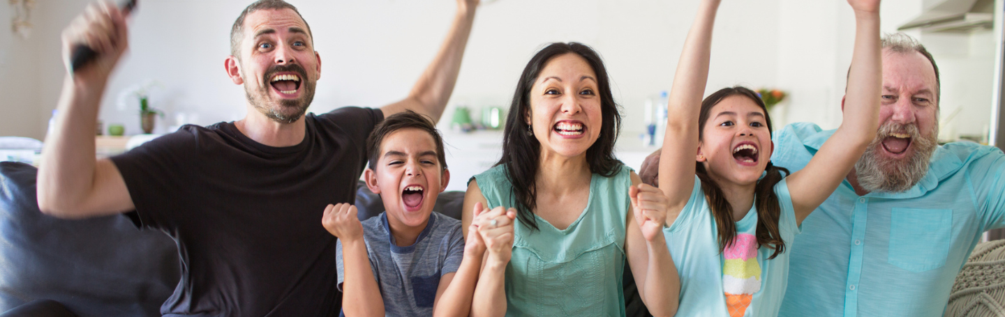 family-cheering-in-front-of-tv - 1